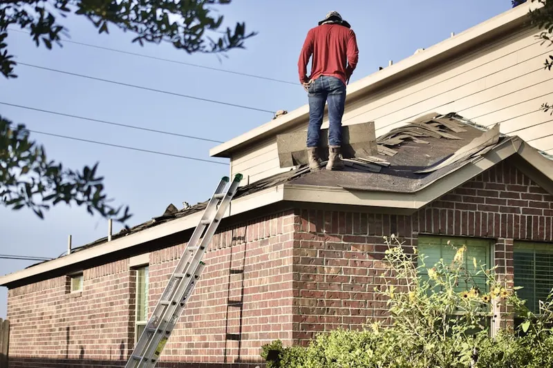 Professional roofer working on a residential roof in Moorehall at Valley Forge